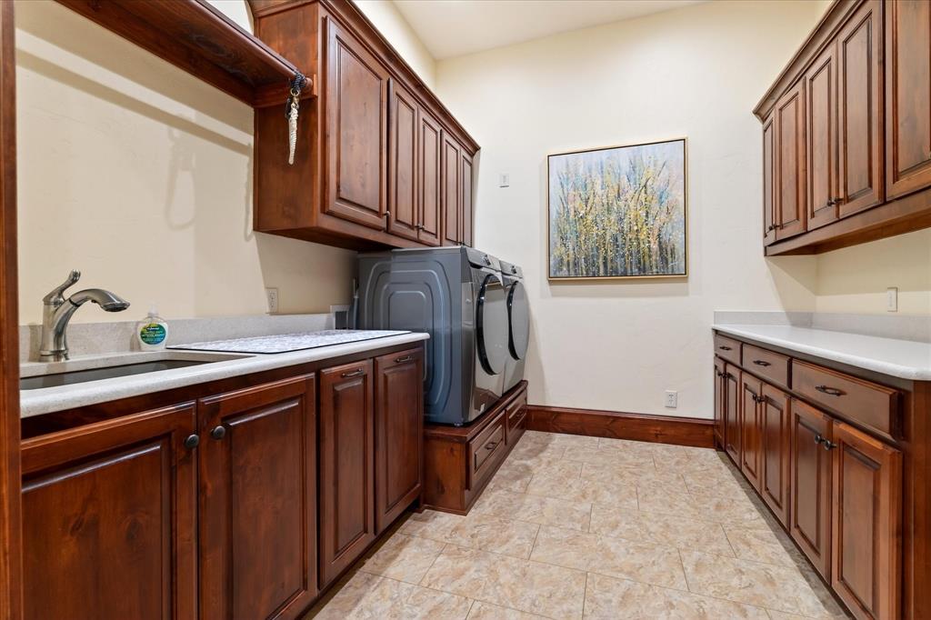 1625 Timber Ridge Trail Cross Roads, TX 76227 - Photo 29 of 40 Laundry room with cabinet space and washer and dryer