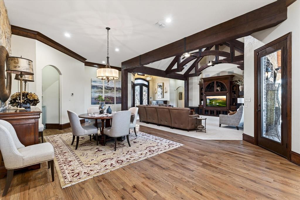 1625 Timber Ridge Trail Cross Roads, TX 76227 - Photo 30 of 40 Dining room featuring wood finished floors, a chandelier, recessed lighting, and arched walkways