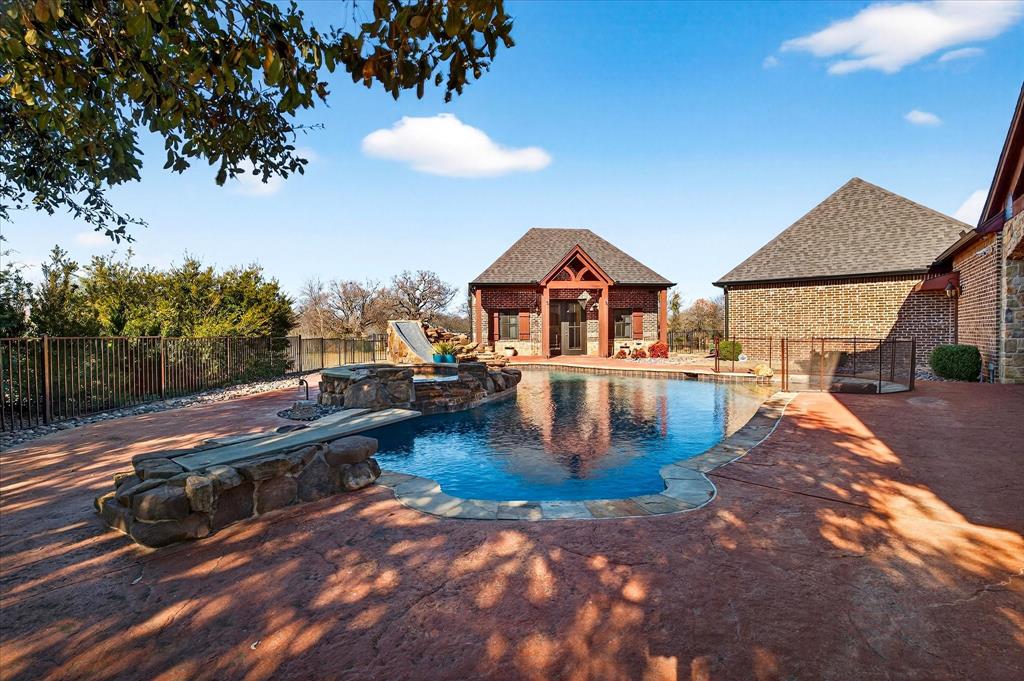 1625 Timber Ridge Trail Cross Roads, TX 76227 - Photo 35 of 40 View of pool featuring a storage structure, an outdoor structure, a fenced backyard, a patio area, and a jacuzzi