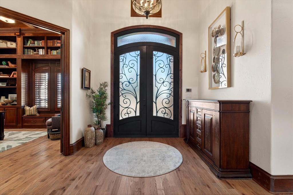 1625 Timber Ridge Trail Cross Roads, TX 76227 - Photo 4 of 40 Entryway featuring french doors, wood finished floors, and arched walkways