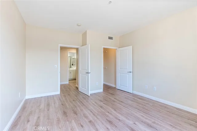 a view of an empty room and wooden floor
