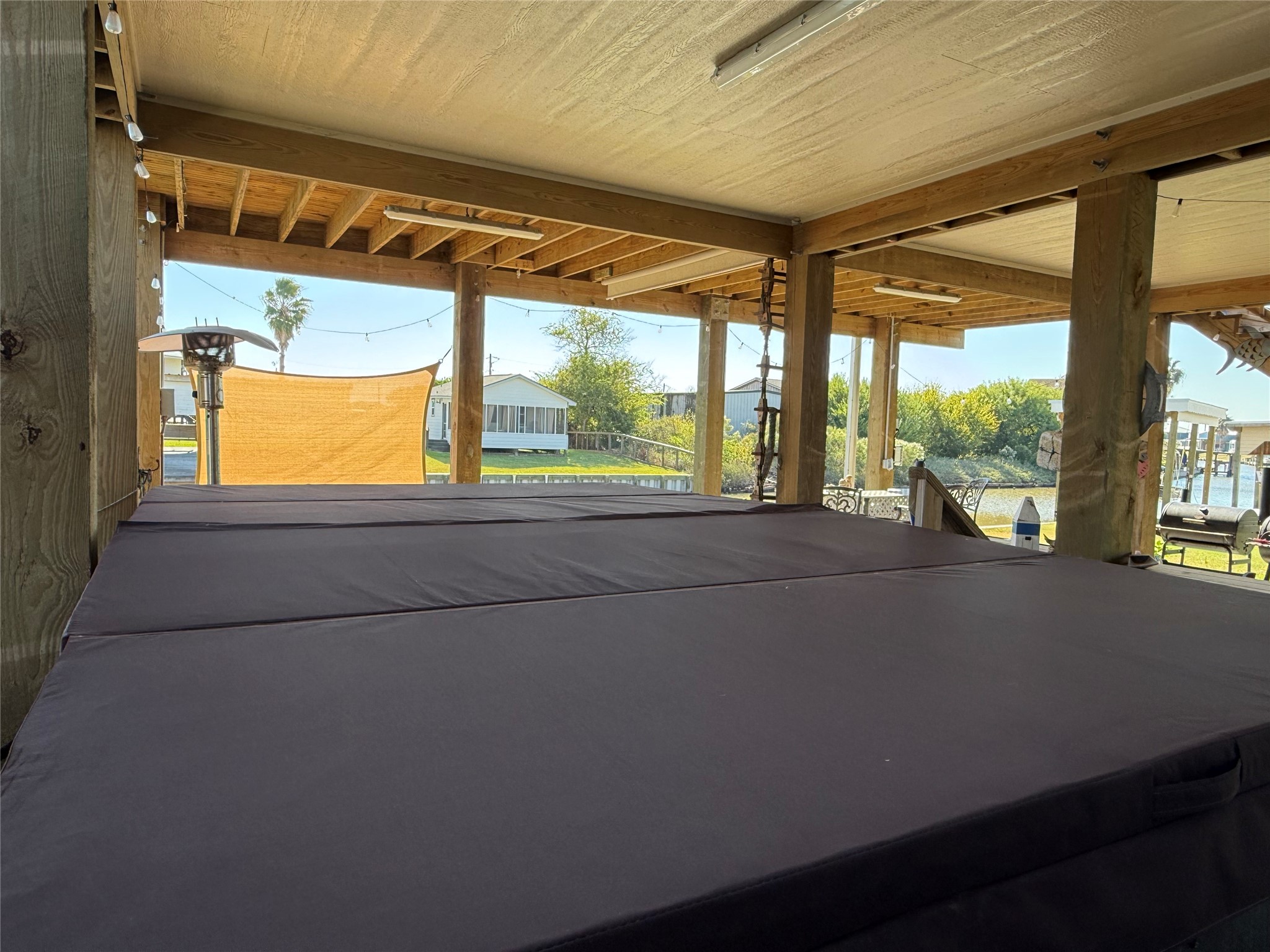 2023 County Road 201 Sargent, TX 77414 - Photo 36 of 45 Swim Spa and hot tub placed in protected area under house and with convenient shower and half bath.