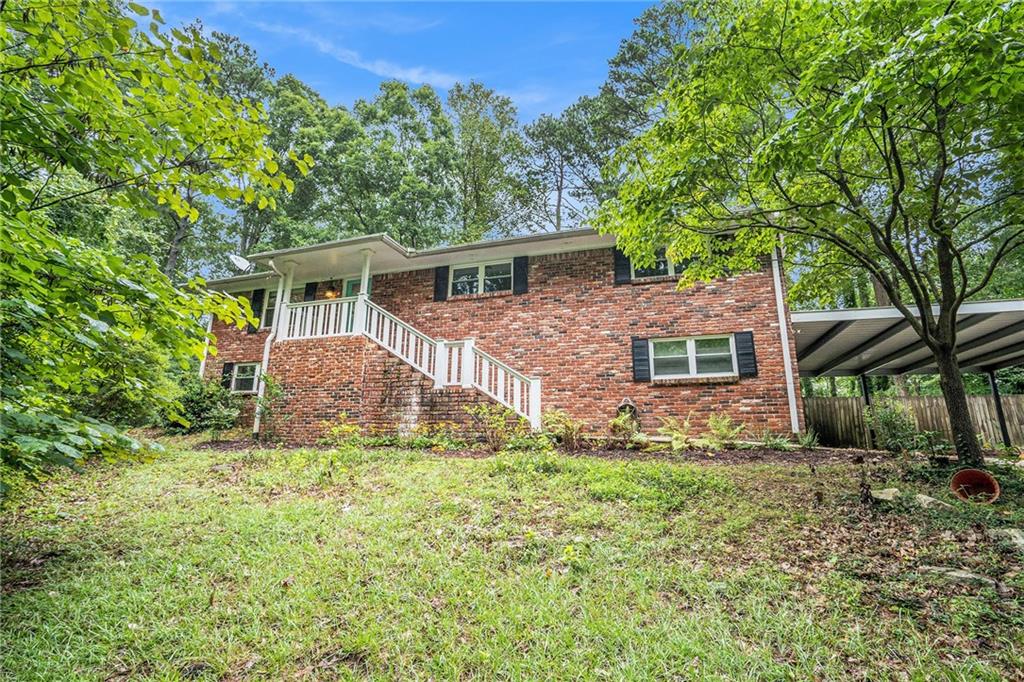 6675 South Dillon Road Austell, GA 30168 - Photo 1 of 1 a view of a house with a yard