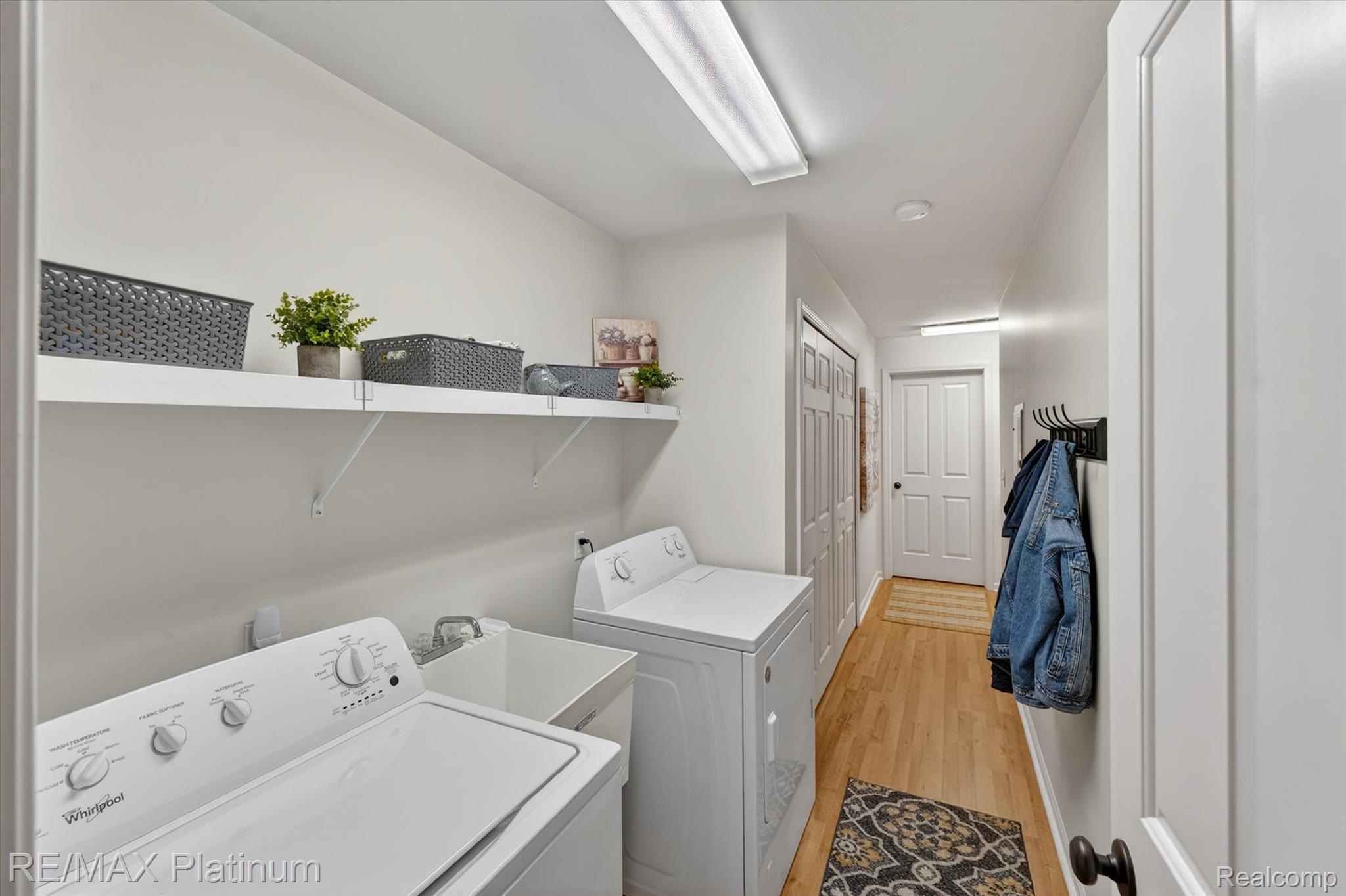 4191 Hampton Ridge Boulevard, Unit 41 Howell, MI 48843 - Photo 17 of 23 Laundry room featuring light wood-type flooring and washer and dryer