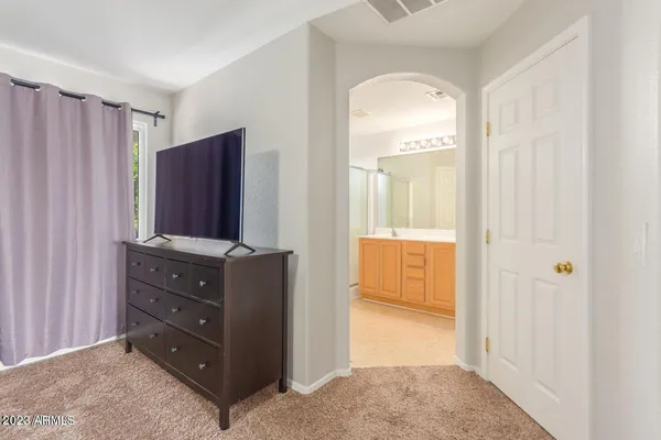 a view of walk in closet and bedroom