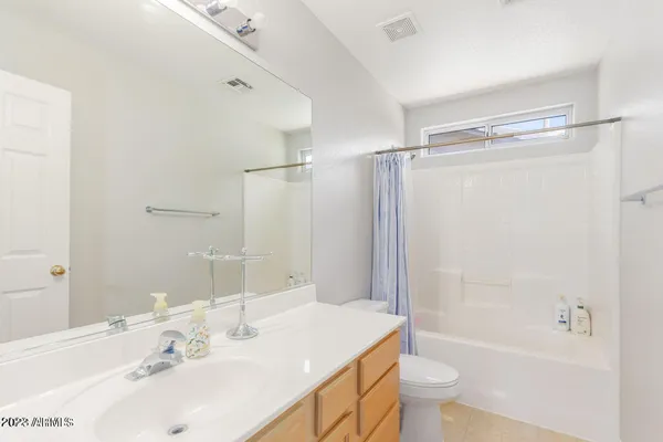 a bathroom with a sink mirror toilet and bathtub