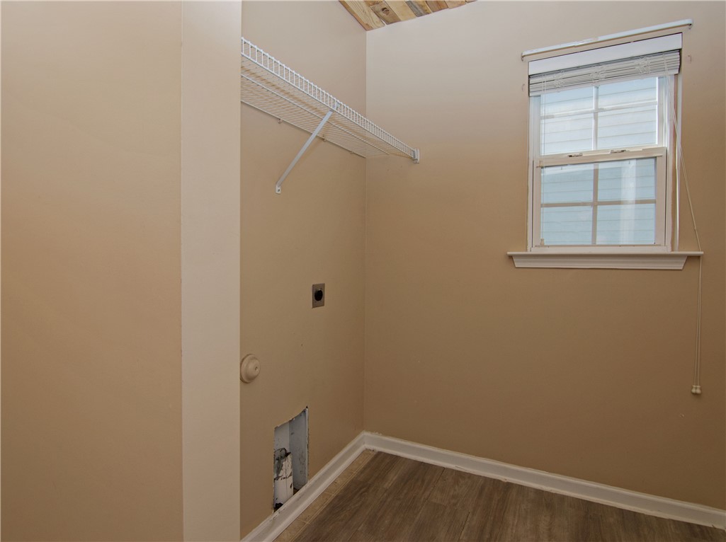 305 North Chestnut Street Seneca, SC 29678 - Photo 36 of 44 Functional laundry space featuring a wire shelf and a window for natural illumination.