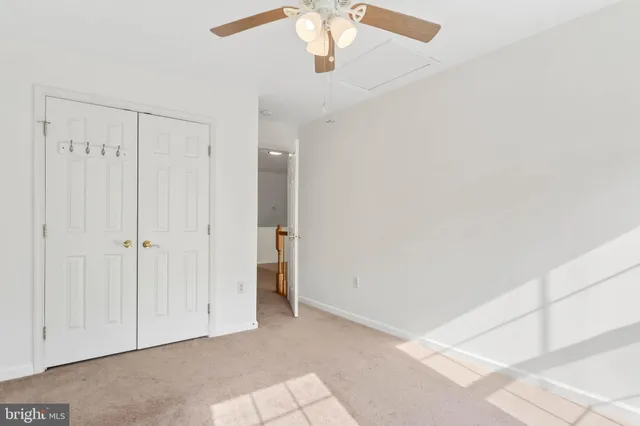 a view of a chandelier fan and entryway