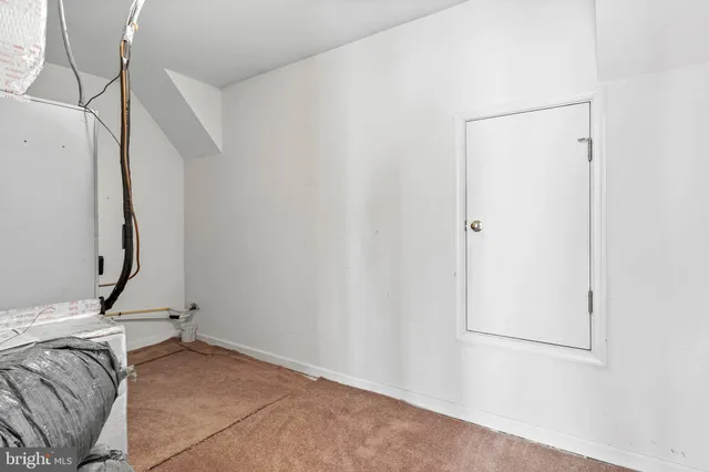 a view of a room with rack and a white door
