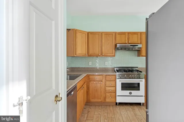 a kitchen with a stove a sink and a microwave