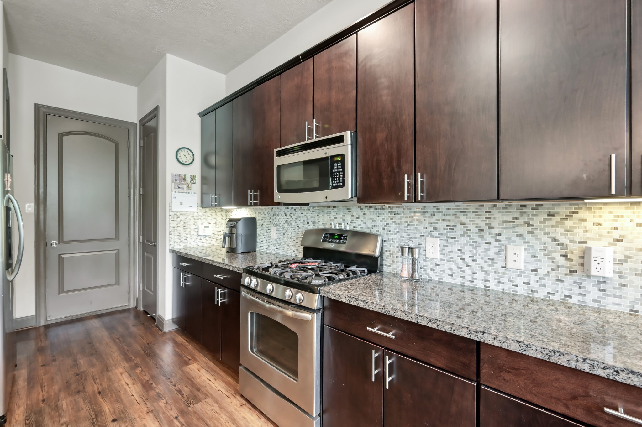 18 Aventura Place Spring, TX 77389 - Photo 15 of 43 a kitchen with granite countertop wooden cabinets and stainless steel appliances