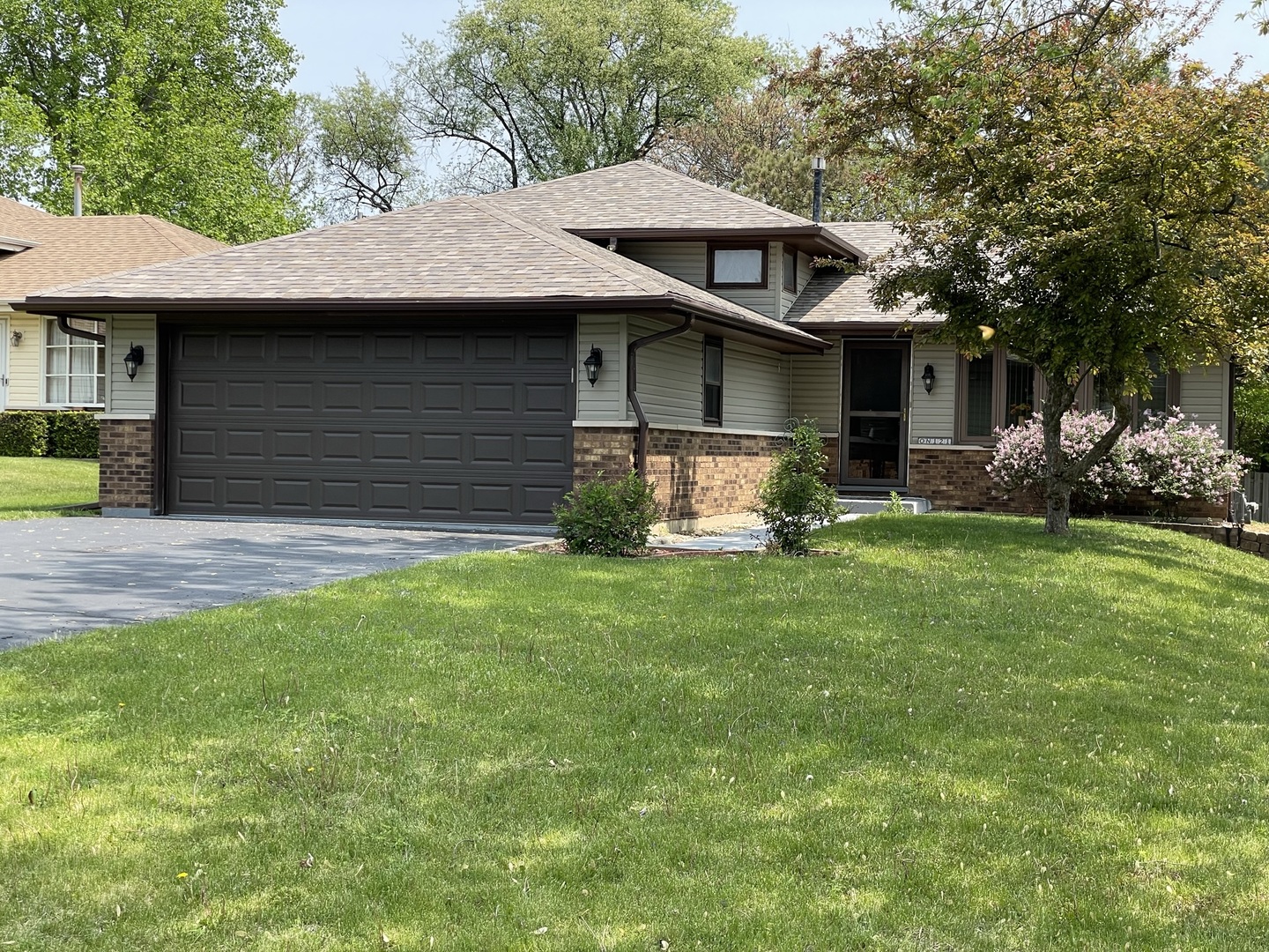 N121 Beverly Street Wheaton, IL 60187 - Photo 2 of 5 a front view of a house with a garden and trees