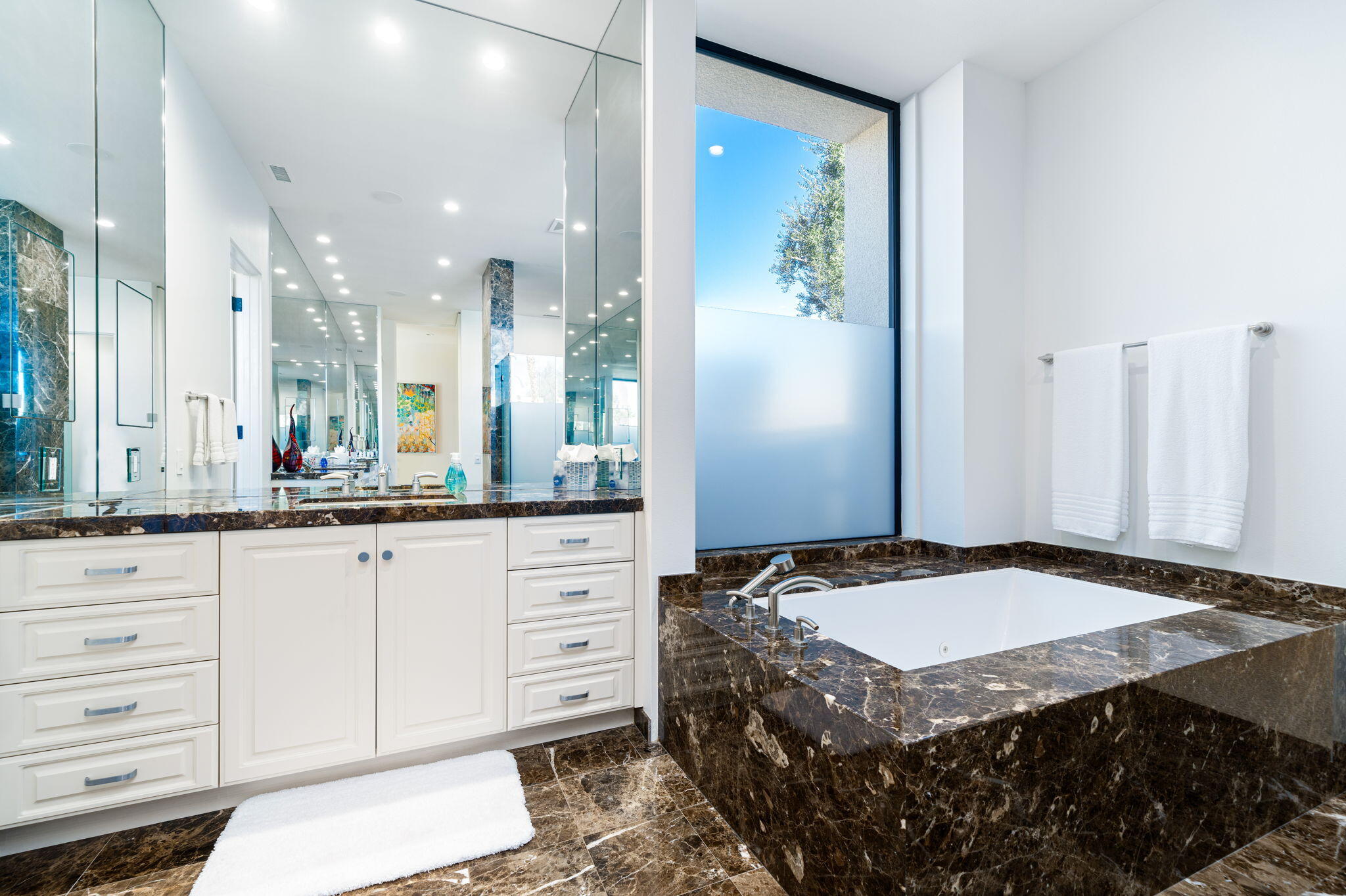 6 Sun Ridge Circle Rancho Mirage, CA 92270 - Photo 37 of 56 a spacious bathroom with a granite countertop sink and a mirror