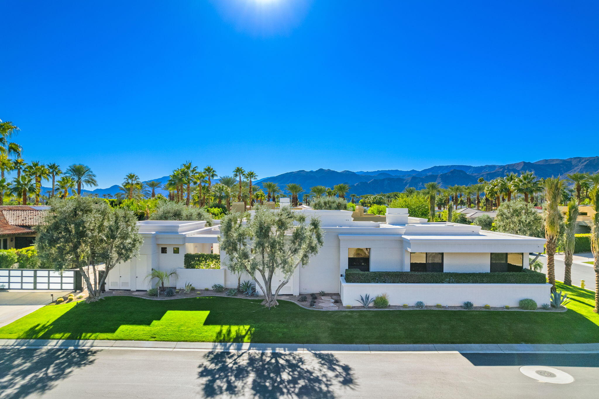 6 Sun Ridge Circle Rancho Mirage, CA 92270 - Photo 4 of 56 a front view of a house with a garden