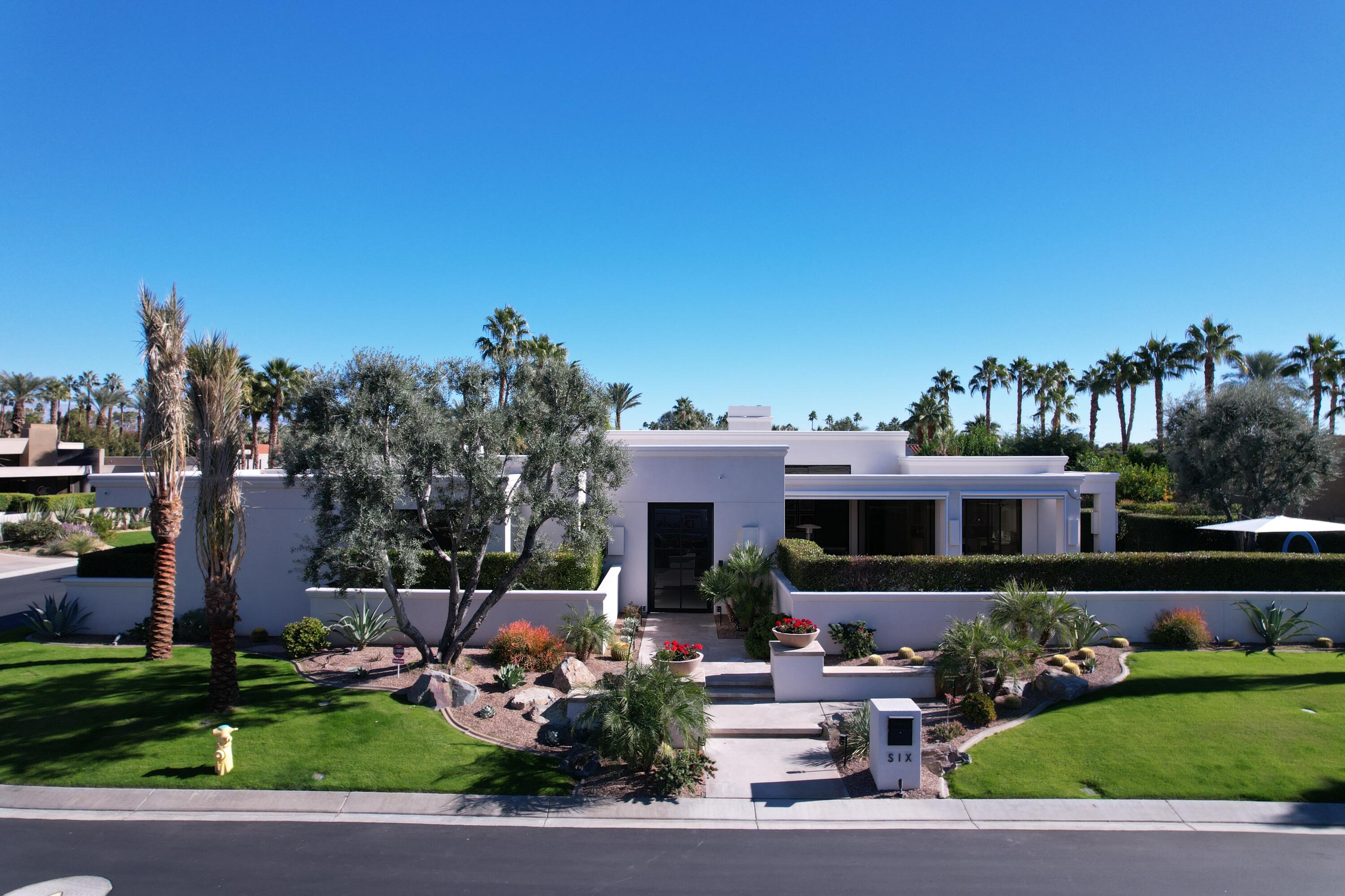 6 Sun Ridge Circle Rancho Mirage, CA 92270 - Photo 48 of 56 a front view of a house with a yard garden and outdoor seating