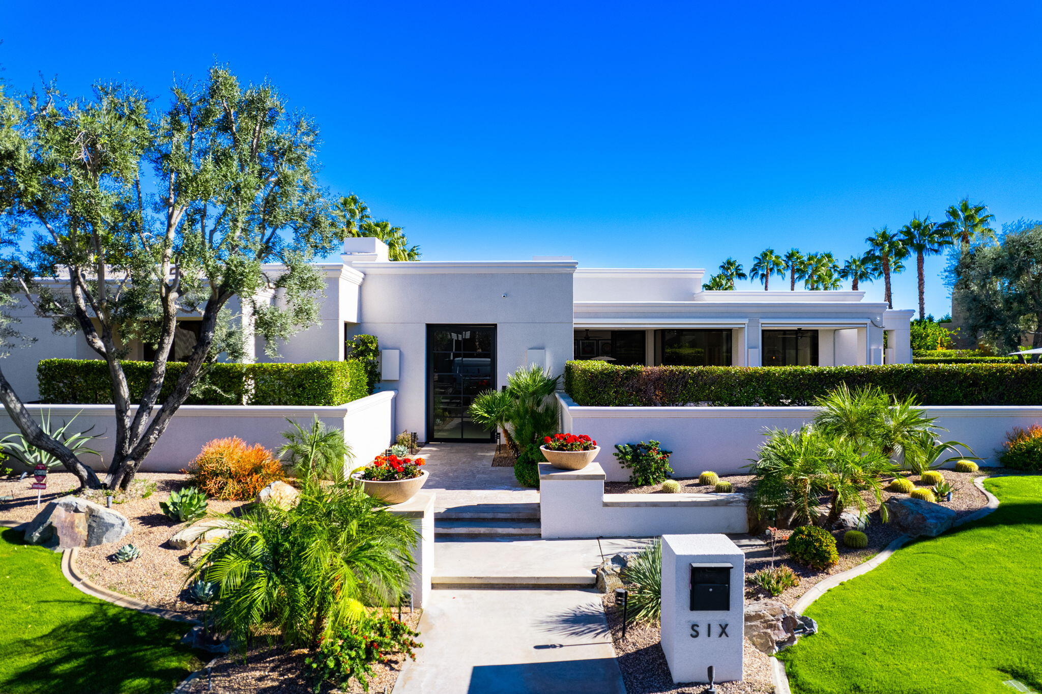 6 Sun Ridge Circle Rancho Mirage, CA 92270 - Photo 7 of 56 a front view of a house with a yard