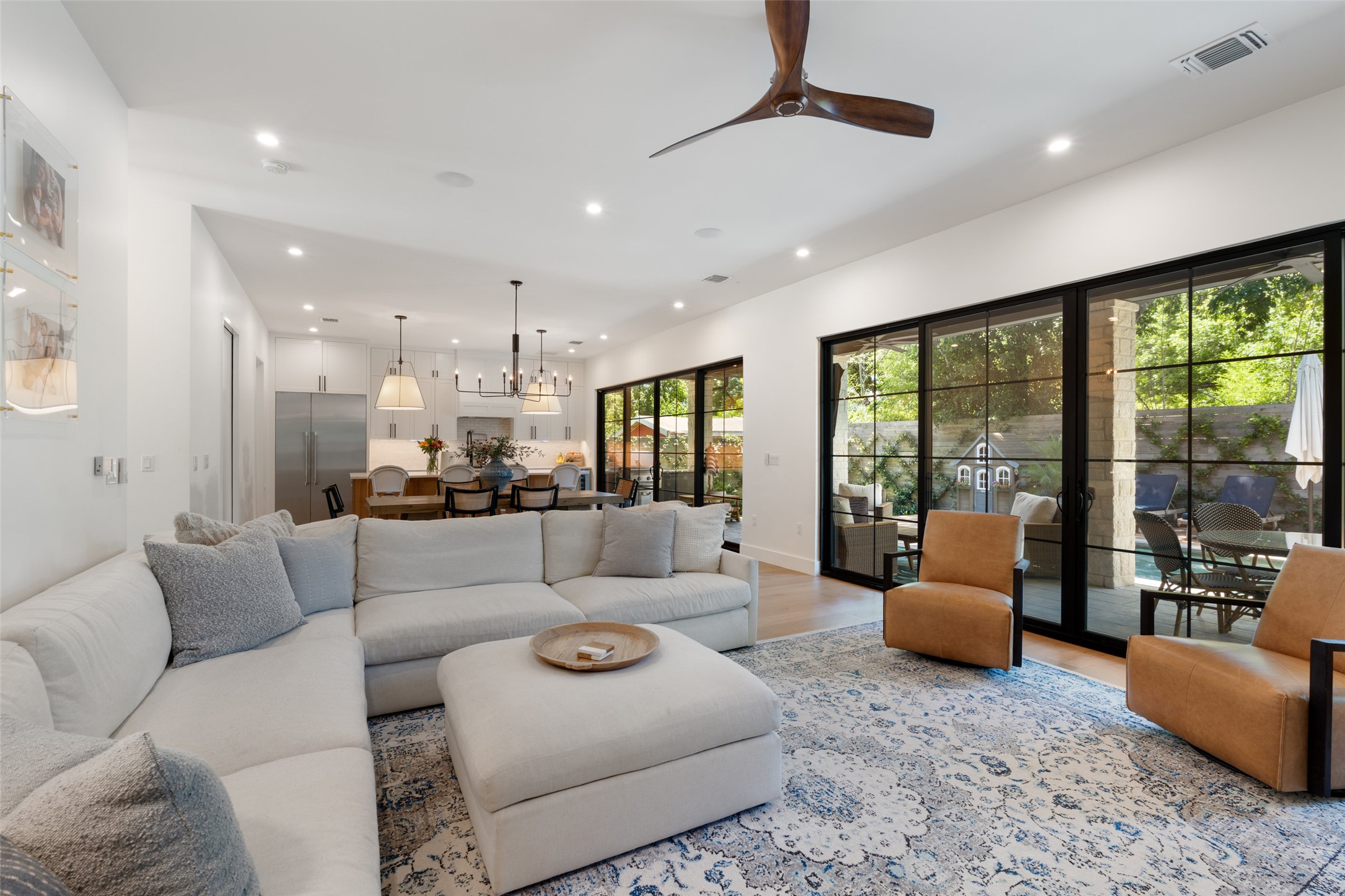 2107 Peach Tree Street Austin, TX 78704 - Photo 12 of 40 Living area featuring recessed lighting, light wood-type flooring, a chandelier, and a ceiling fan