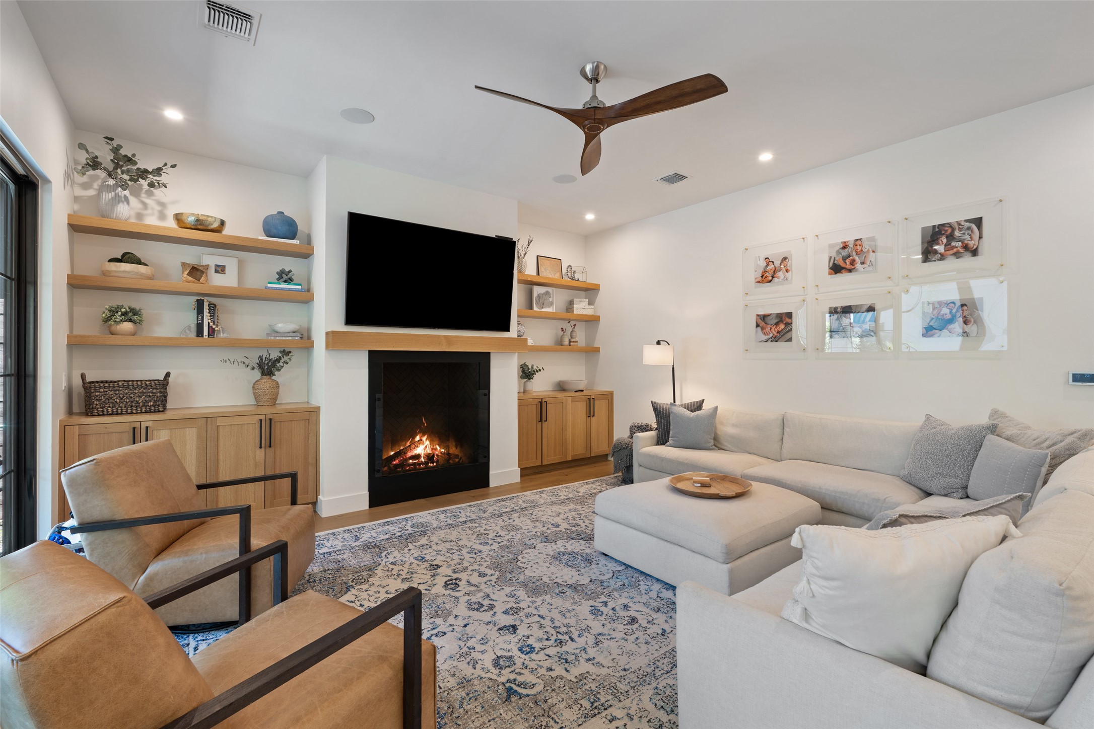 2107 Peach Tree Street Austin, TX 78704 - Photo 13 of 40 Living room with a warm lit fireplace, ceiling fan, wood finished floors, and recessed lighting