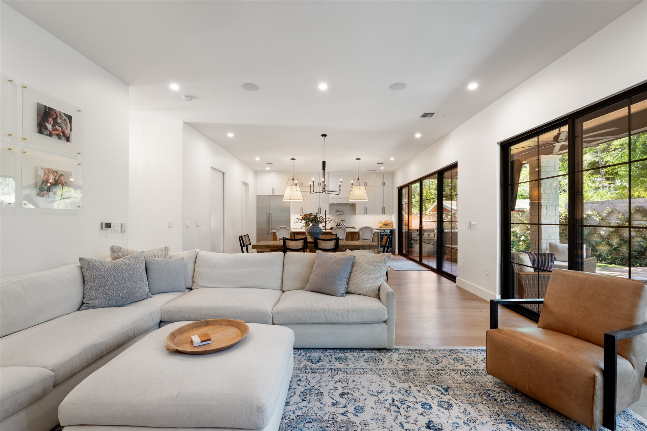 2107 Peach Tree Street Austin, TX 78704 - Photo 14 of 40 Living room featuring wood finished floors, recessed lighting, a chandelier, and baseboards