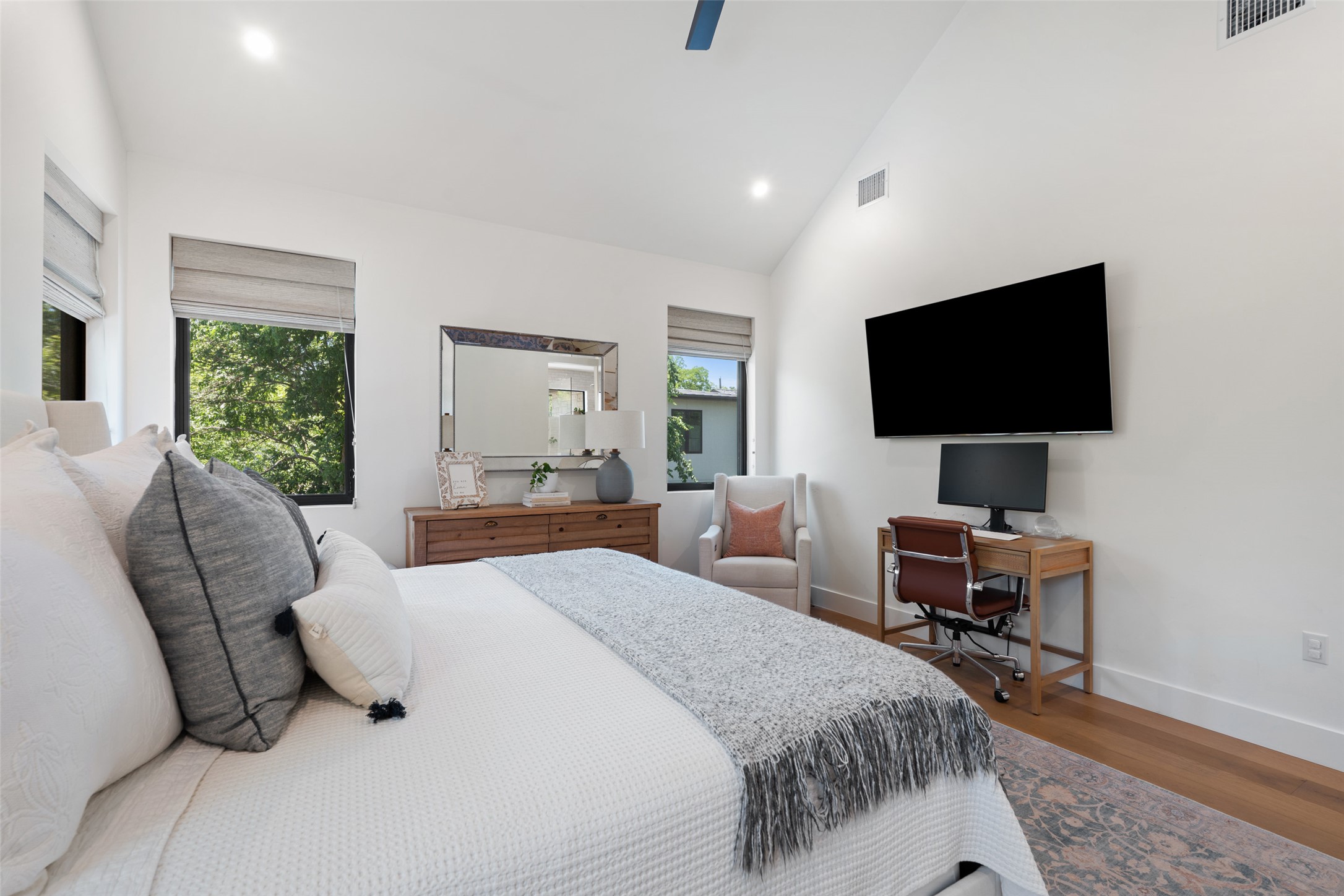 2107 Peach Tree Street Austin, TX 78704 - Photo 20 of 40 Bedroom with multiple windows, wood finished floors, baseboards, recessed lighting, and high vaulted ceiling