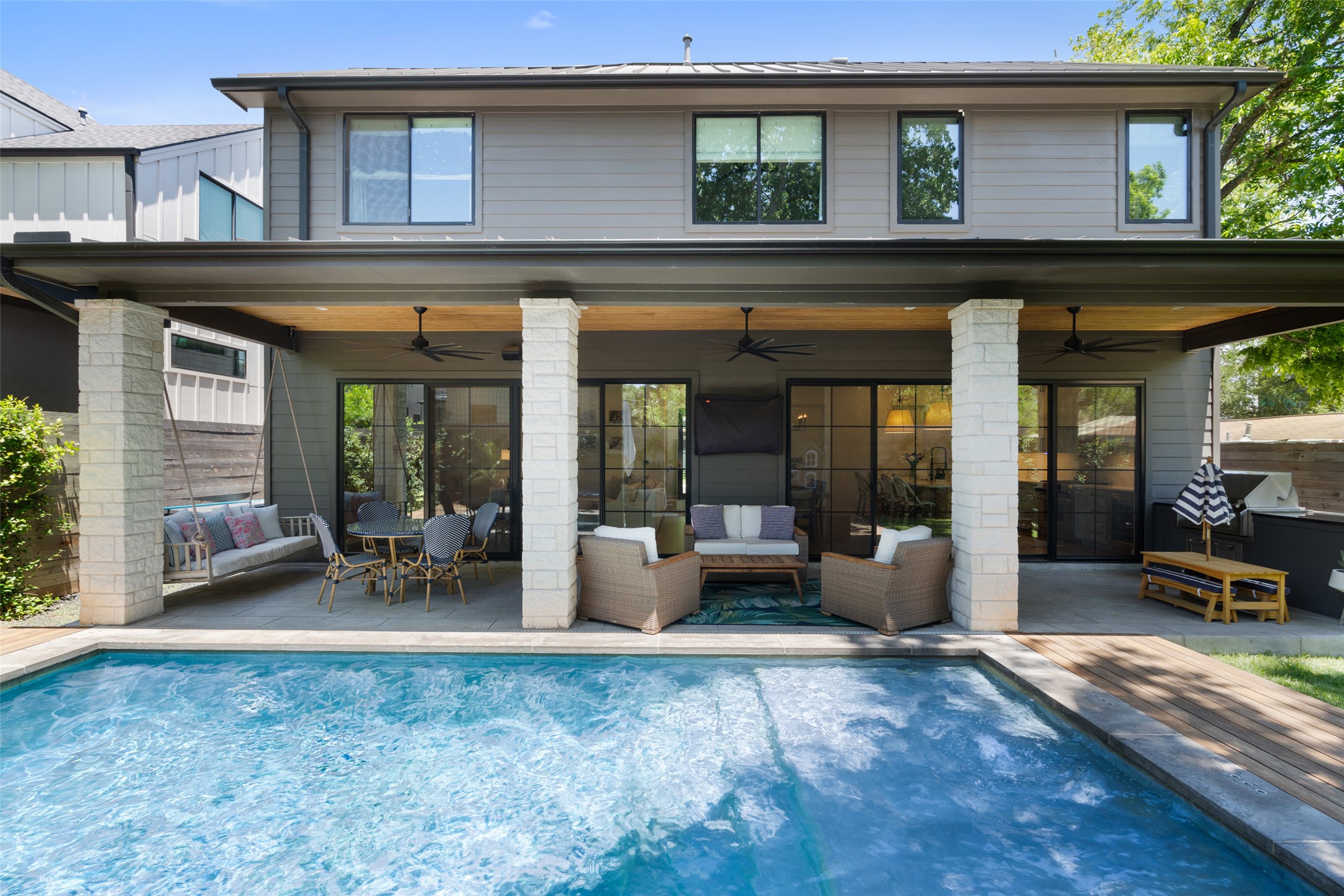 2107 Peach Tree Street Austin, TX 78704 - Photo 31 of 40 Back of house with a ceiling fan, a patio area, and an outdoor pool