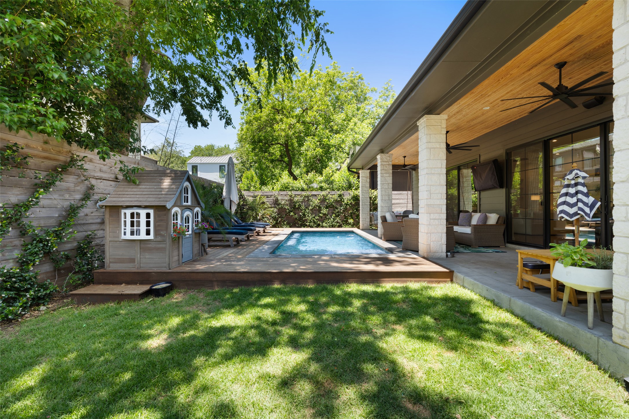 2107 Peach Tree Street Austin, TX 78704 - Photo 33 of 40 View of yard with a ceiling fan, a wooden deck, an outdoor living space, an outbuilding, and a storage unit