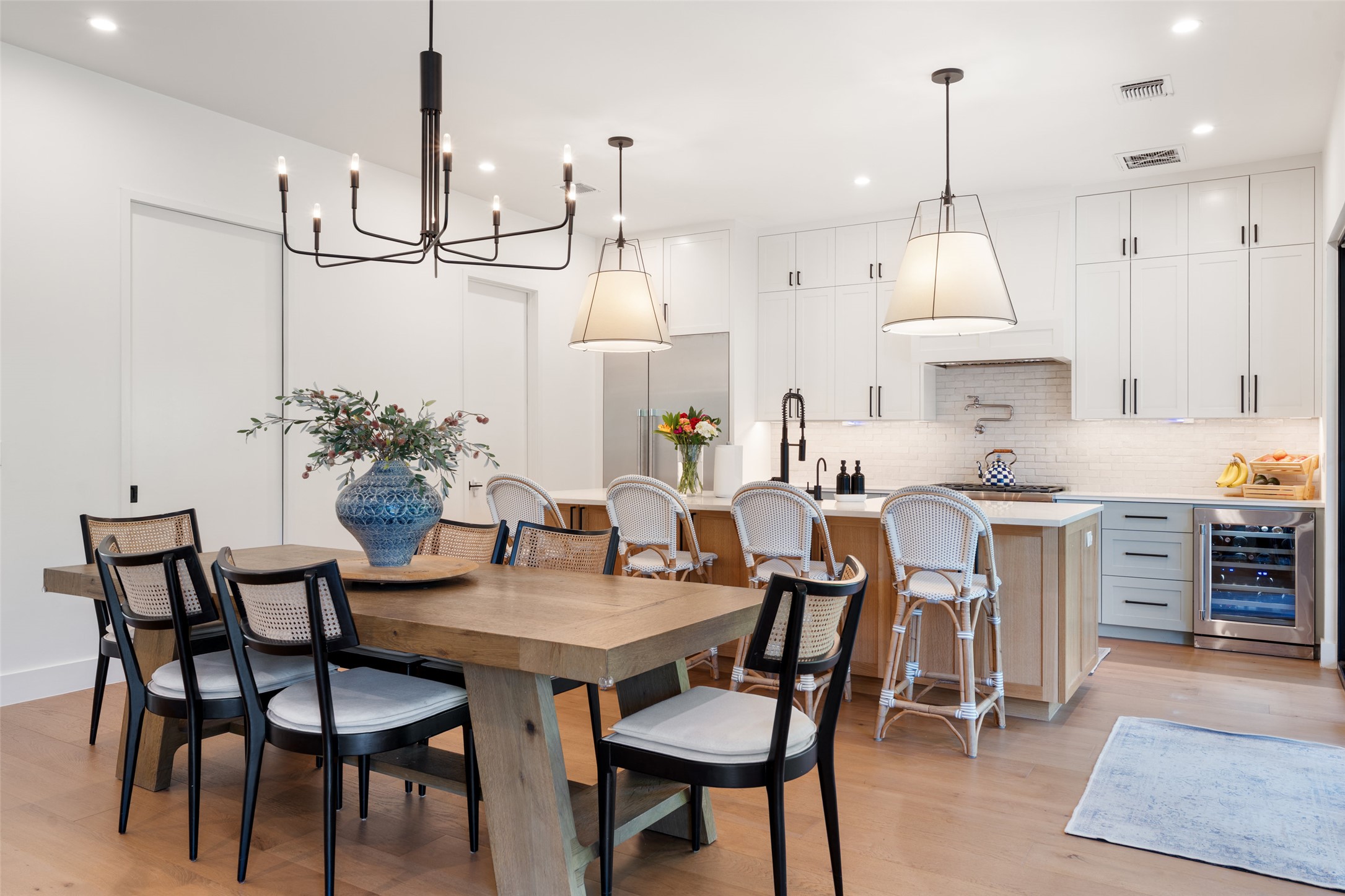 2107 Peach Tree Street Austin, TX 78704 - Photo 4 of 40 Dining area with wine cooler, recessed lighting, light wood finished floors, and a chandelier