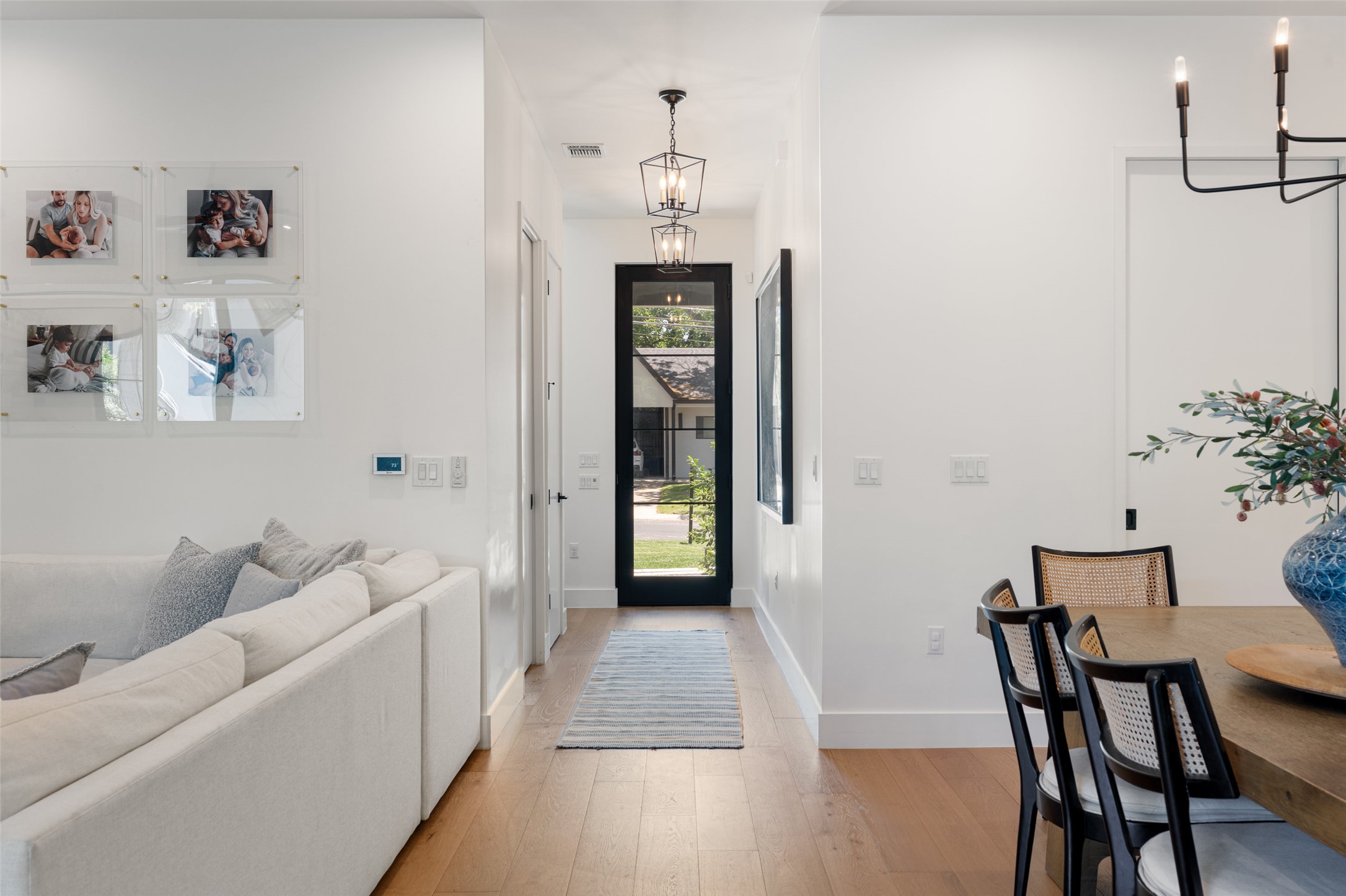 2107 Peach Tree Street Austin, TX 78704 - Photo 8 of 40 Foyer entrance featuring a chandelier, light wood-type flooring, and baseboards