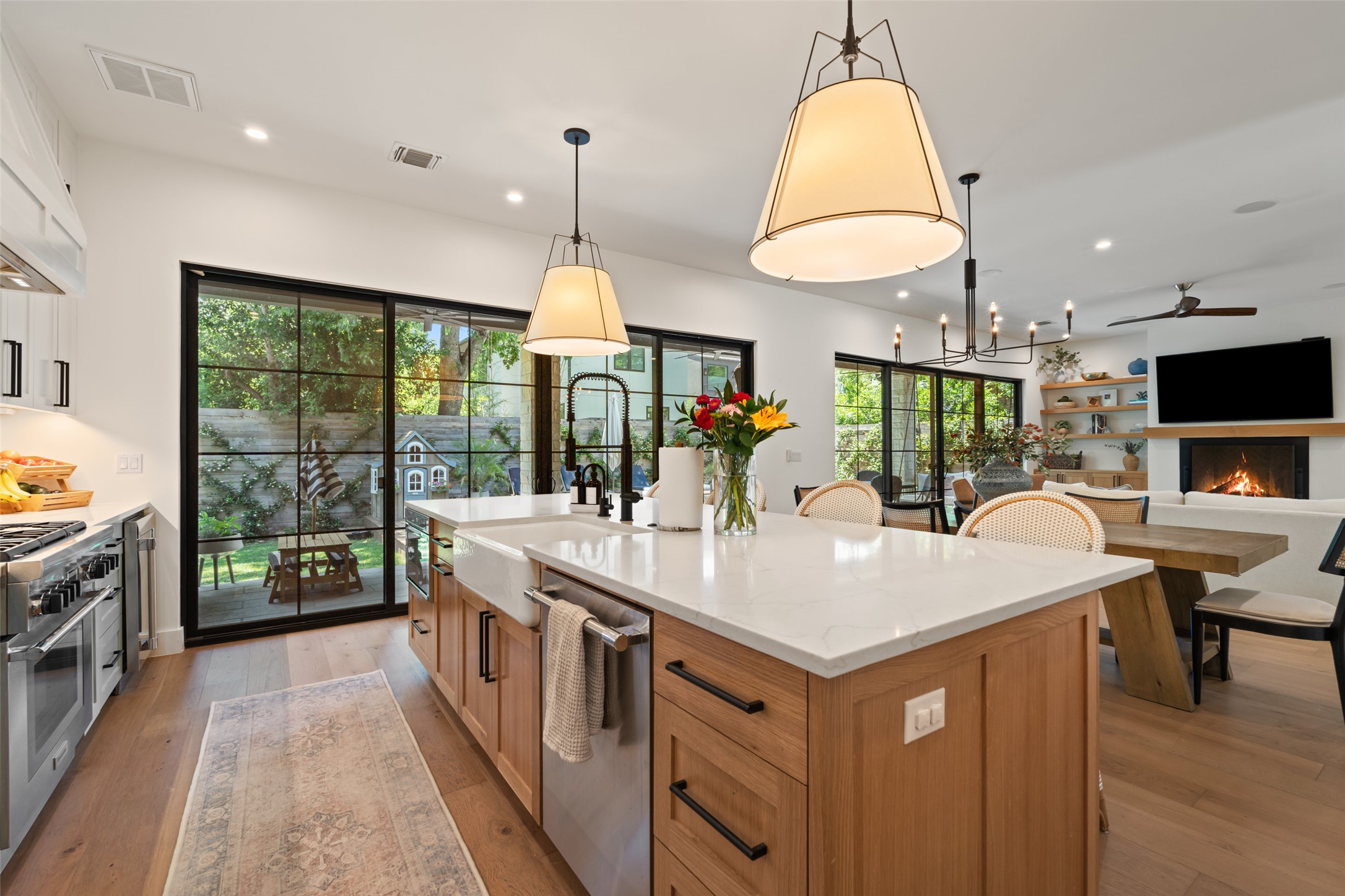 2107 Peach Tree Street Austin, TX 78704 - Photo 10 of 40 Kitchen featuring appliances with stainless steel finishes, a sink, a ceiling fan, light wood-style floors, and recessed lighting