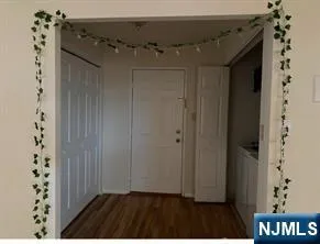 a view of a hallway with wooden floor