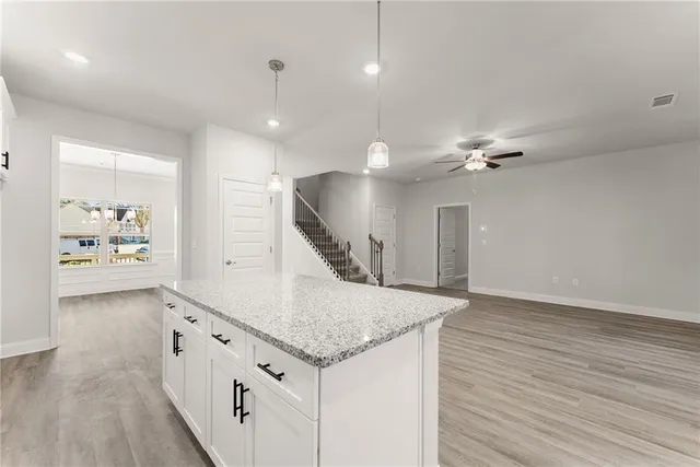 an entryway with staircase and kitchen view
