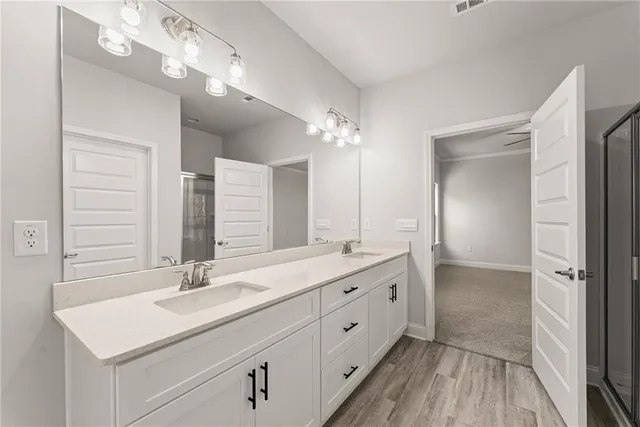 a bathroom with a double vanity sink and mirror