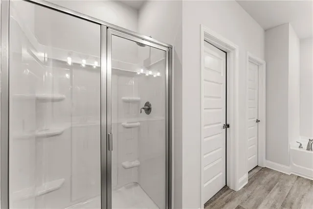 a bathroom with a glass shower door