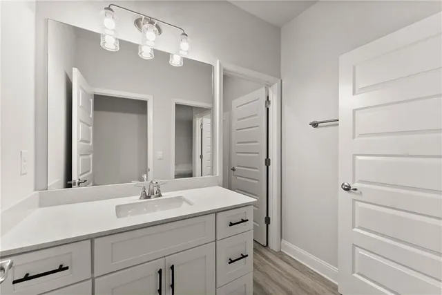 a bathroom with a sink vanity and a mirror