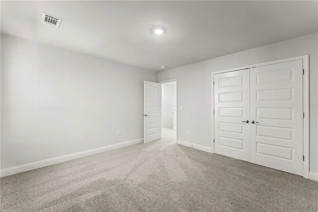an empty room with closet area