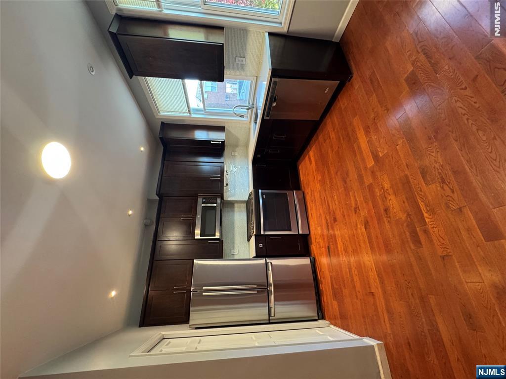 307 Henry Street, Unit 2 Fairview, NJ 07022 - Photo 2 of 10 a large kitchen with stainless steel appliances granite countertop a refrigerator and a stove top oven