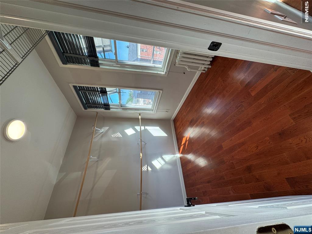 307 Henry Street, Unit 2 Fairview, NJ 07022 - Photo 6 of 10 a view of livingroom with hardwood floor and window