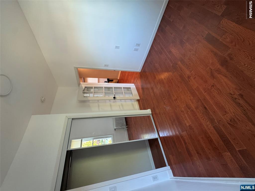 307 Henry Street, Unit 2 Fairview, NJ 07022 - Photo 7 of 10 a view of empty room with wooden floor and window
