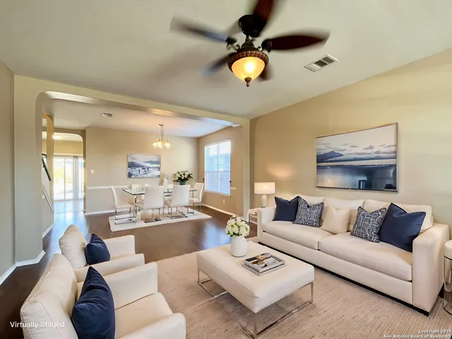 a living room with furniture and a large mirror