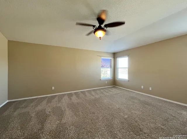 a view of room with a ceiling fan