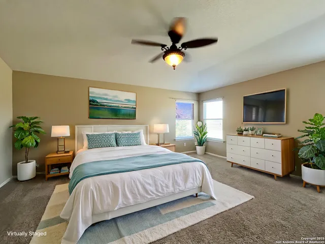 a bedroom with a bed a chandelier and a couch