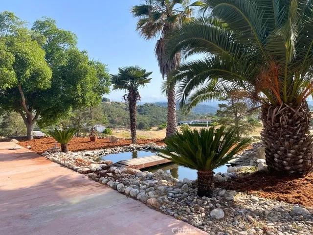 a view of an empty room with wooden floor and stairs