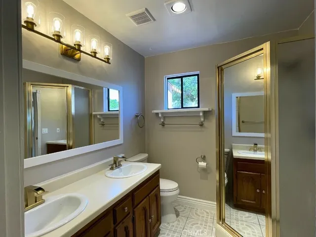 a bathroom with a toilet and a mirror