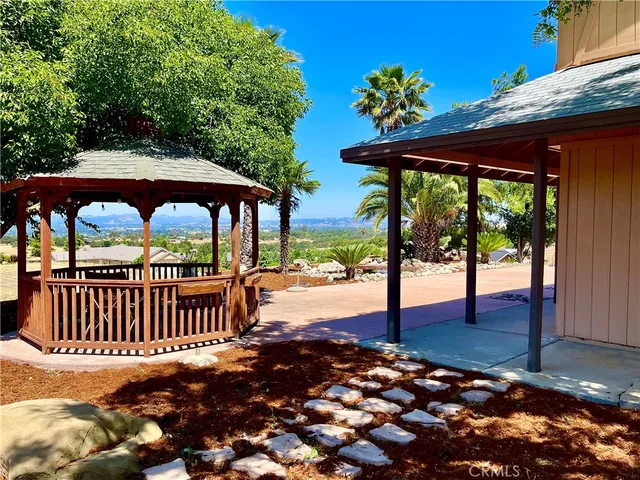 a view of a patio with a table chairs and wooden floor
