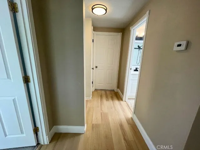an empty room with a ceiling fan and a window