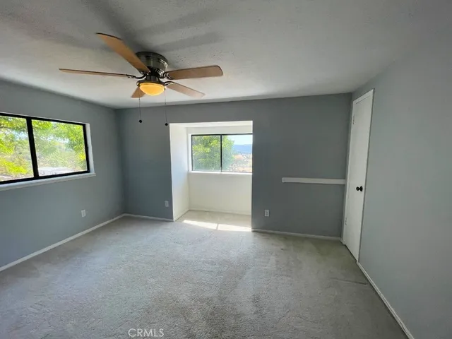 a view of a livingroom with a ceiling fan and window