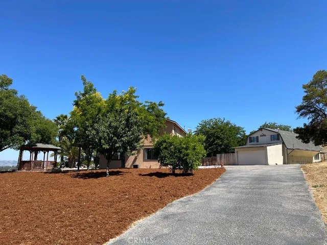 a front view of a house with a yard and a garage
