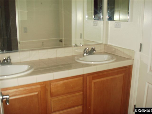 1045 South University Park Loop Reno, NV 89512 - Photo 6 of 9 a bathroom with a sink and a mirror