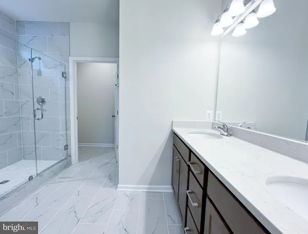 a bathroom with a sink a mirror and shower