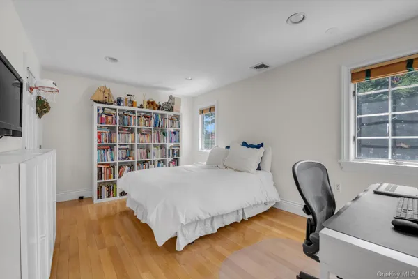 a bedroom with a bed and a chair